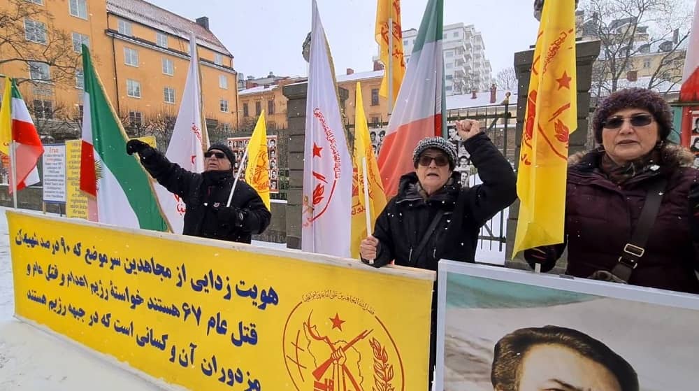 Sweden, April 1, 2022: In snowy and cold weather, freedom-loving Iranians, supporters of the People's Mojahedin Organization of Iran (PMOI/MEK), rally in front of Stockholm court. MEK supporters are seeking justice for 30,000 political prisoners executed by the mullahs’ regime in the 1988 massacre. 
