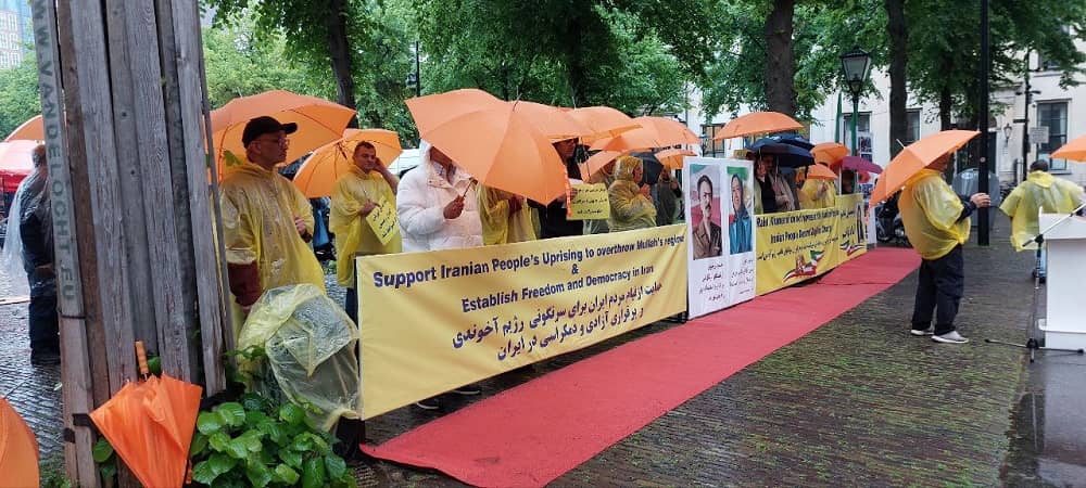 Freedom-loving Iranians, MEK supporters rally in rainy weather in support of the Iran protests – The Hague, May 20, 2022