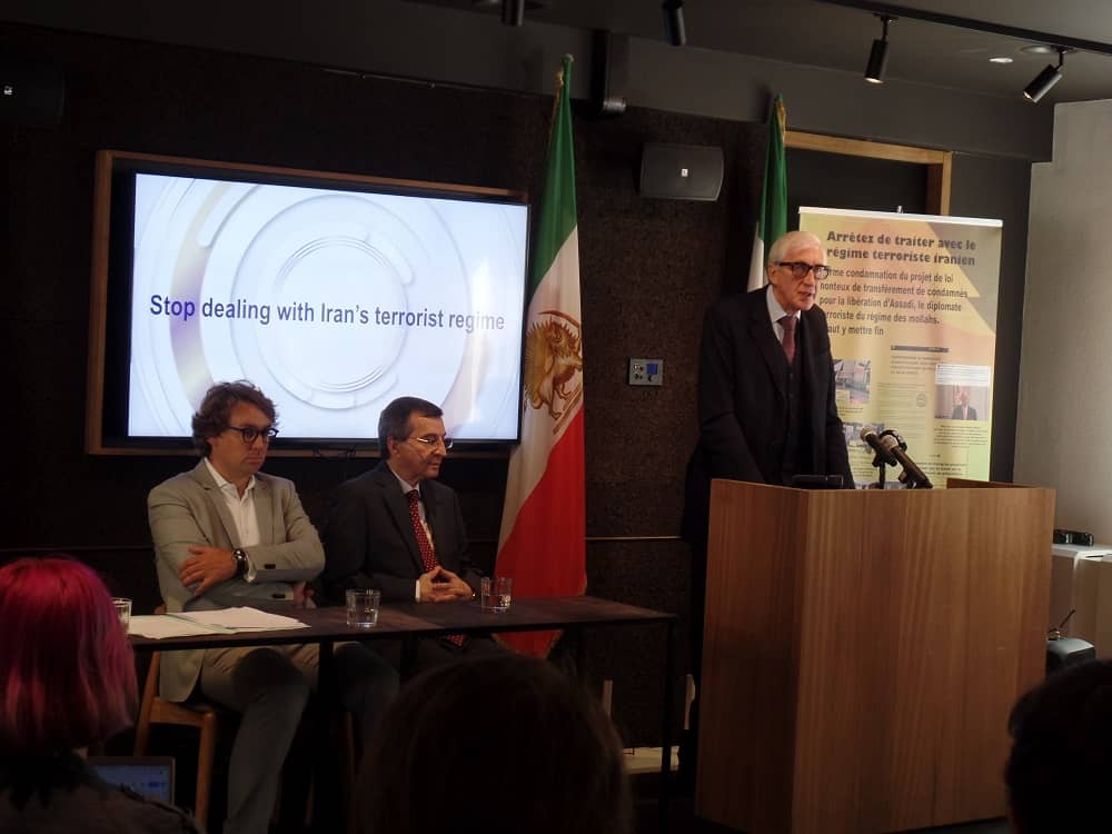 The press conference of the National Council of Resistance of Iran in Brussels: sitting from the left Rik Vanreusel, Farzin Hashemi and standing while speaking Georges Henri Beauthier