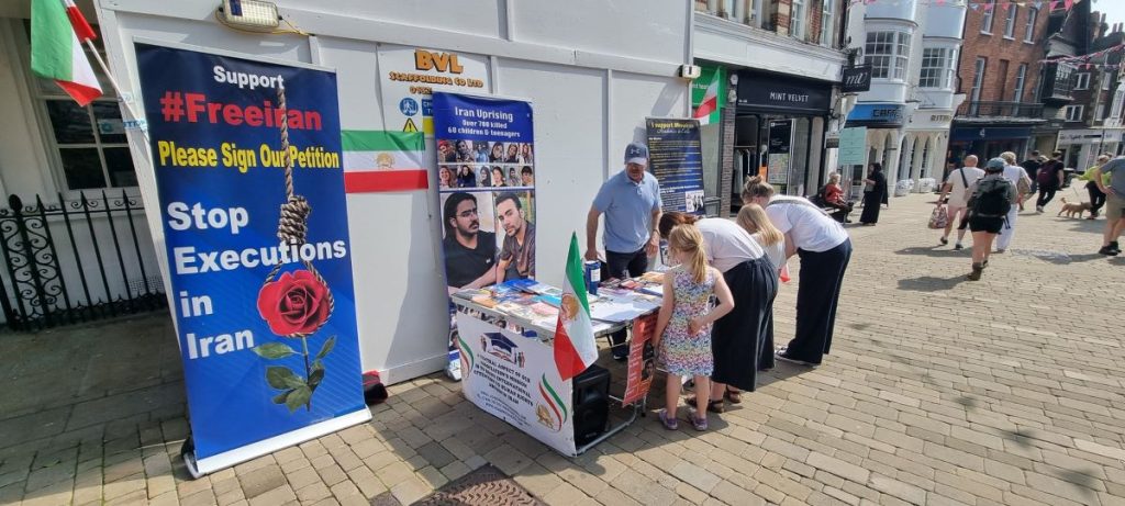 Winchester—May 11, 2024: Freedom-loving Iranians and academics living in England, supporters of the People's Mojahedin Organization of Iran (PMOI/MEK), organized a book exhibition and petition collection to back the Iranian Revolution.