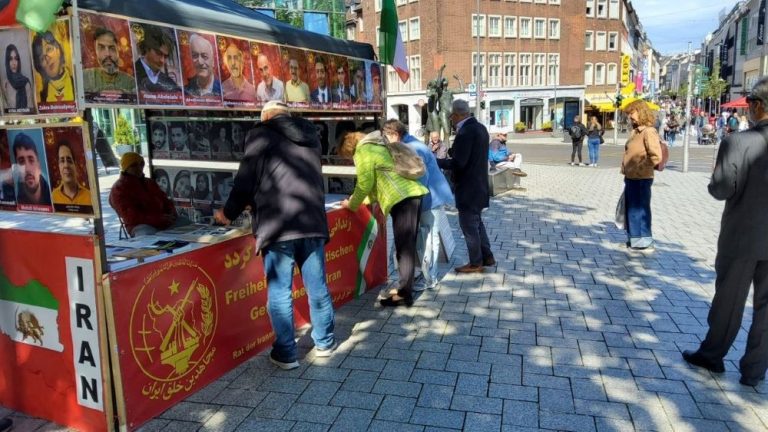 MEK supporters in Aachen set up a book table, calling for broad participation in the June 20 Free Iran rally in Paris.