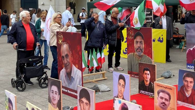 MEK supporters in Hamburg protest executions and promote the June 20 Free Iran rally in Paris.