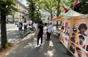 PMOI supporters in Paris display photos and books highlighting executions in Iran and calls for a democratic republic.