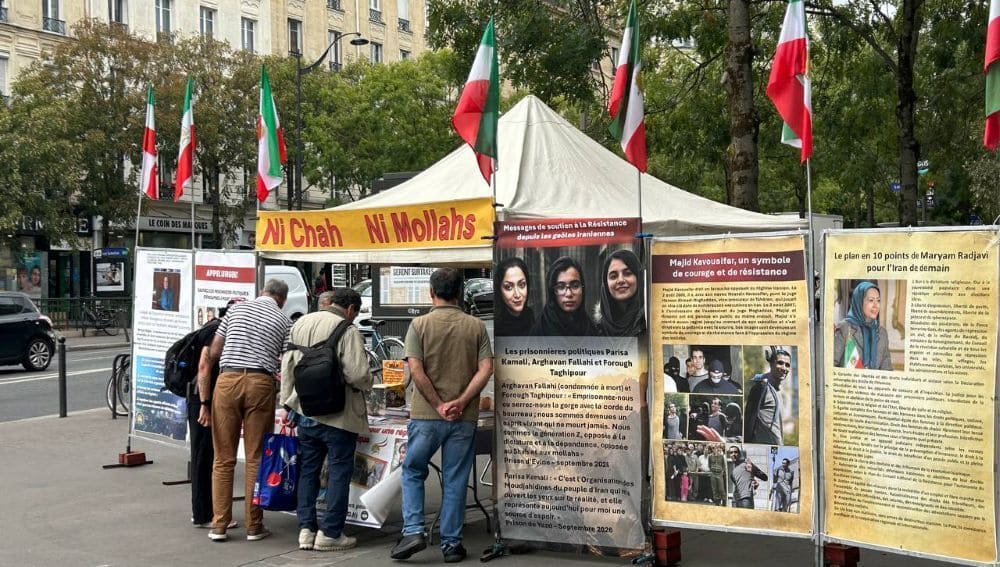 PMOI supporters in Paris display photos to condemn Iran’s executions of political prisoners and protesters.