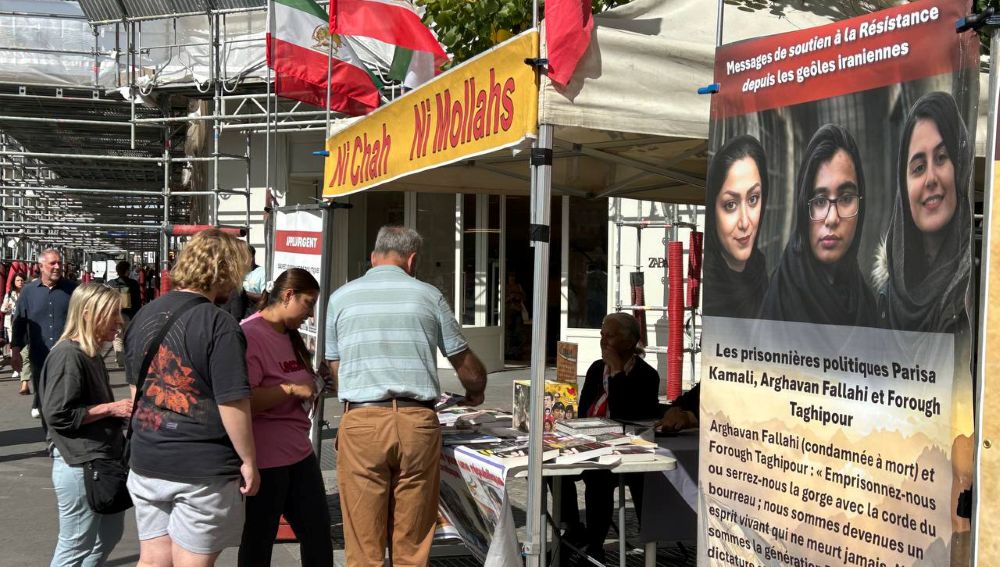 PMOI supporters in Paris display photos to condemn Iran’s executions of political prisoners and protesters.