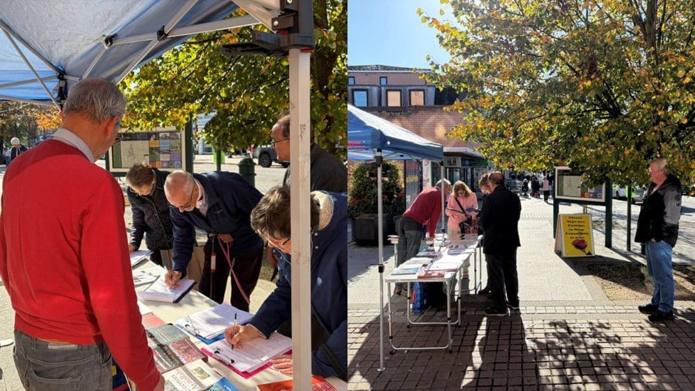 Members of the Academics in Exile Association in New Milton, UK, hold a book table and photo exhibition highlighting executions and human rights abuses in Iran.